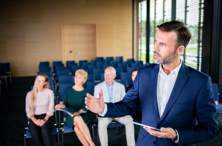 Businessman coach in the auditorium